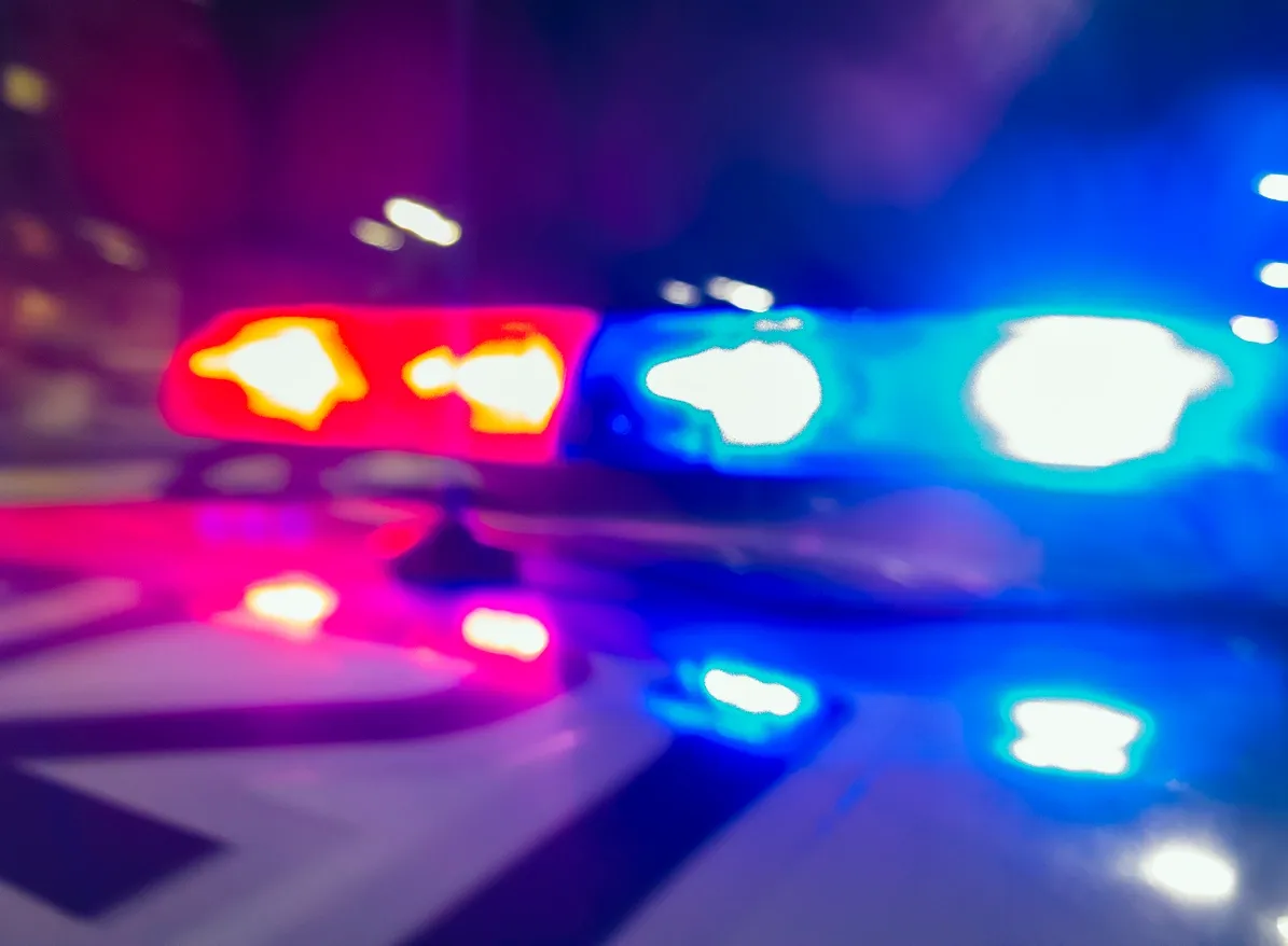 rs=w_1280 (14) Blurred police car lights flashing red and blue at night.