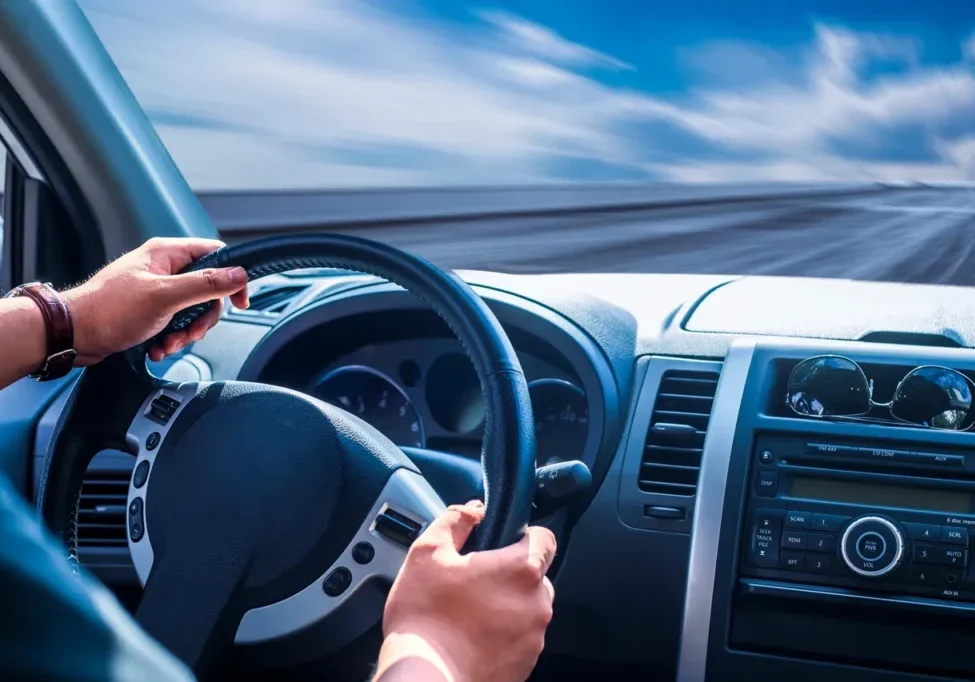 A person driving a car on the highway.